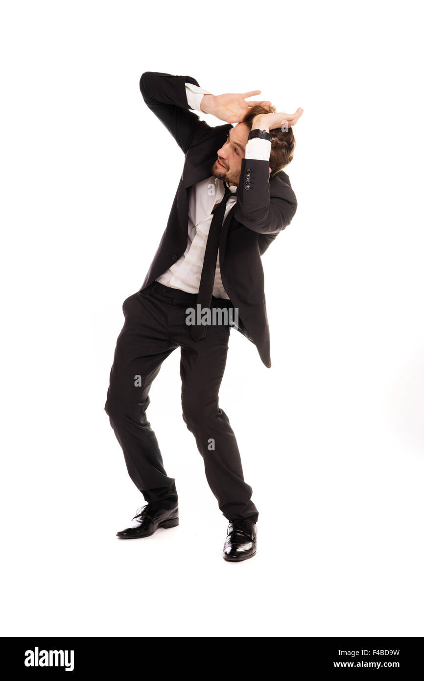 Stylish businessman cowering in fear Stock Photo