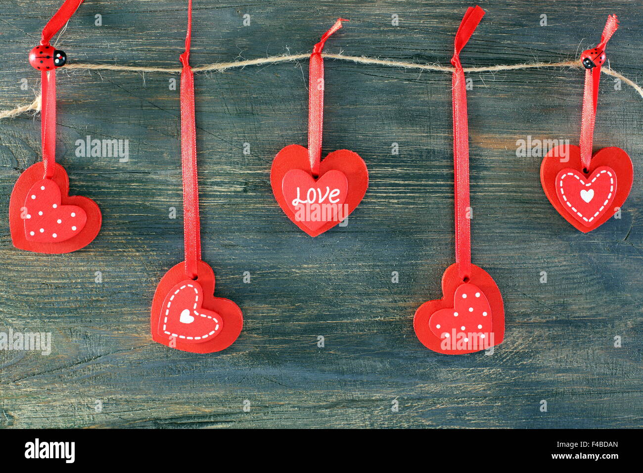 Red hearts on a wooden wall. Stock Photo