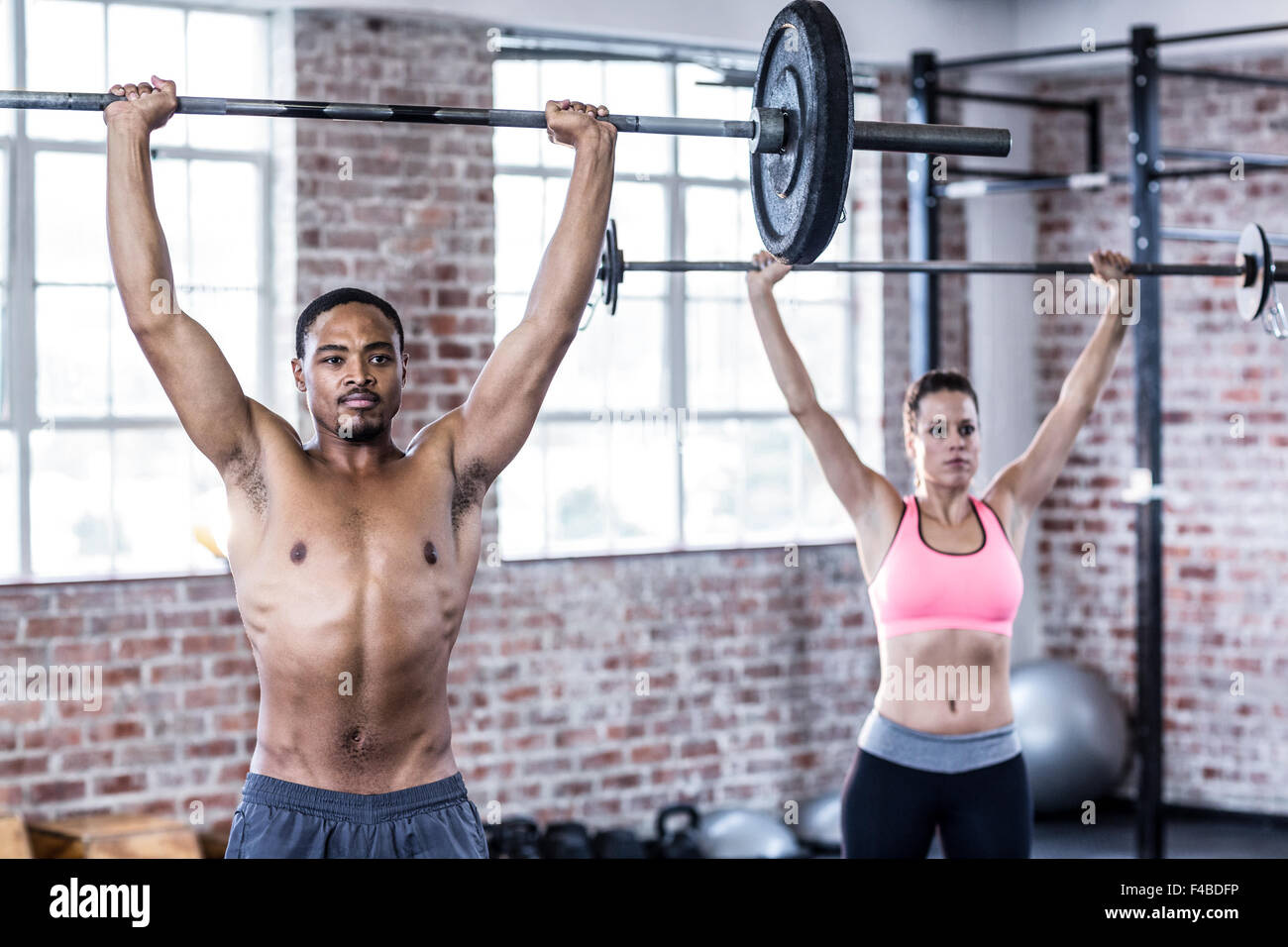 Fit couple lifting weight together Stock Photo - Alamy