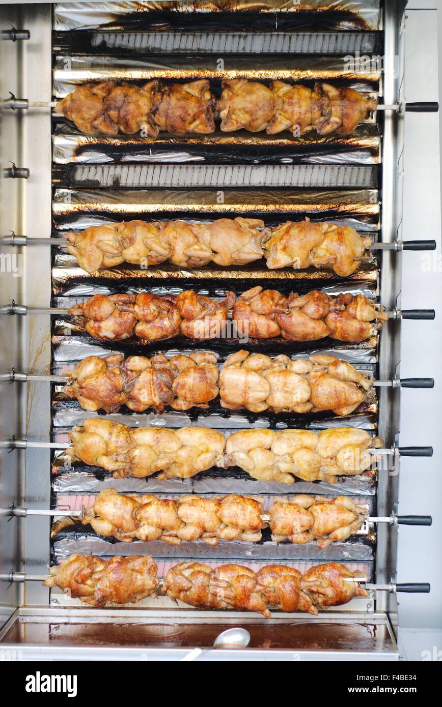 roasting chickens on a vertical grill Stock Photo Alamy