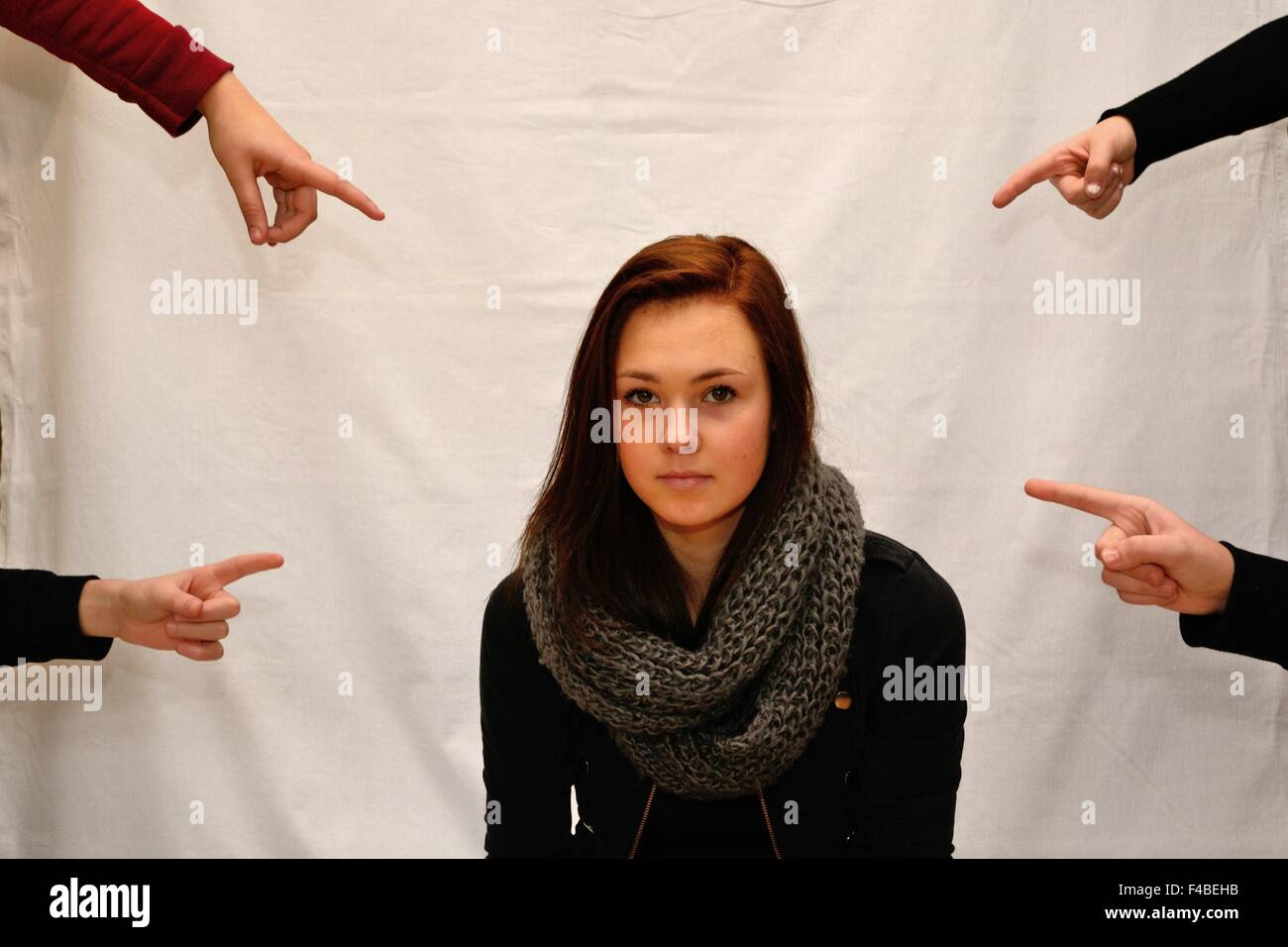 Persons with finger pointing on girls Stock Photo