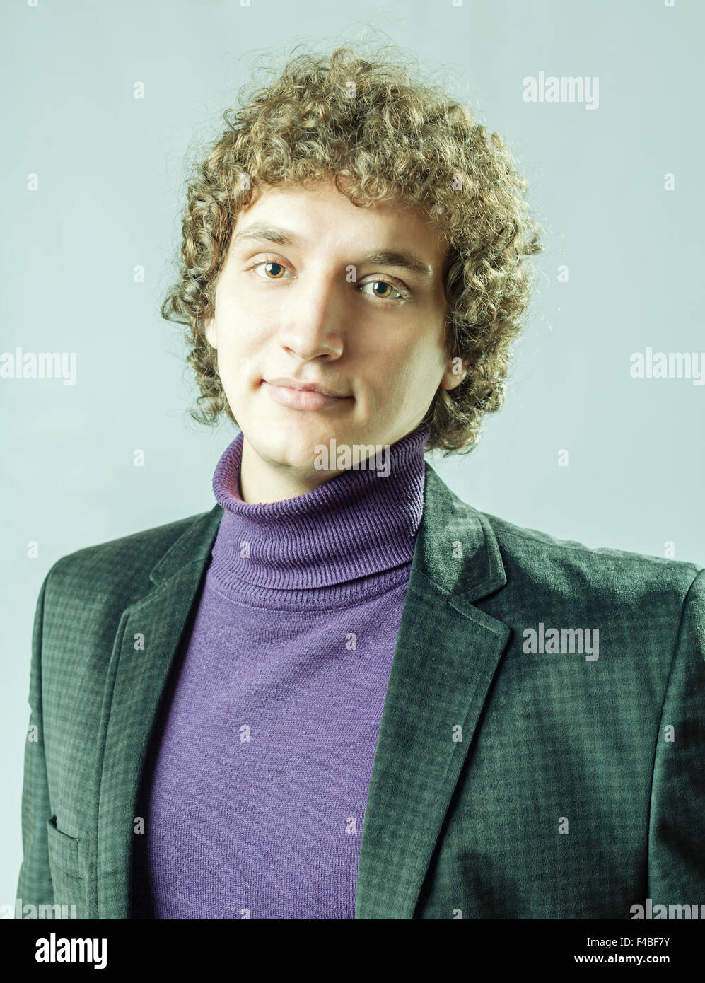 portrait of a young guy with curly hair Stock Photo