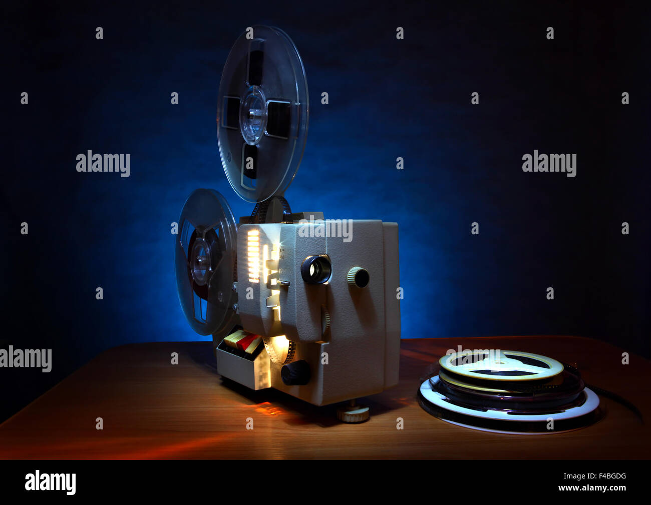 Original old big movie reel for 35 mm cinema projector loaded with film in  vintage color effect on neutral background Stock Photo - Alamy