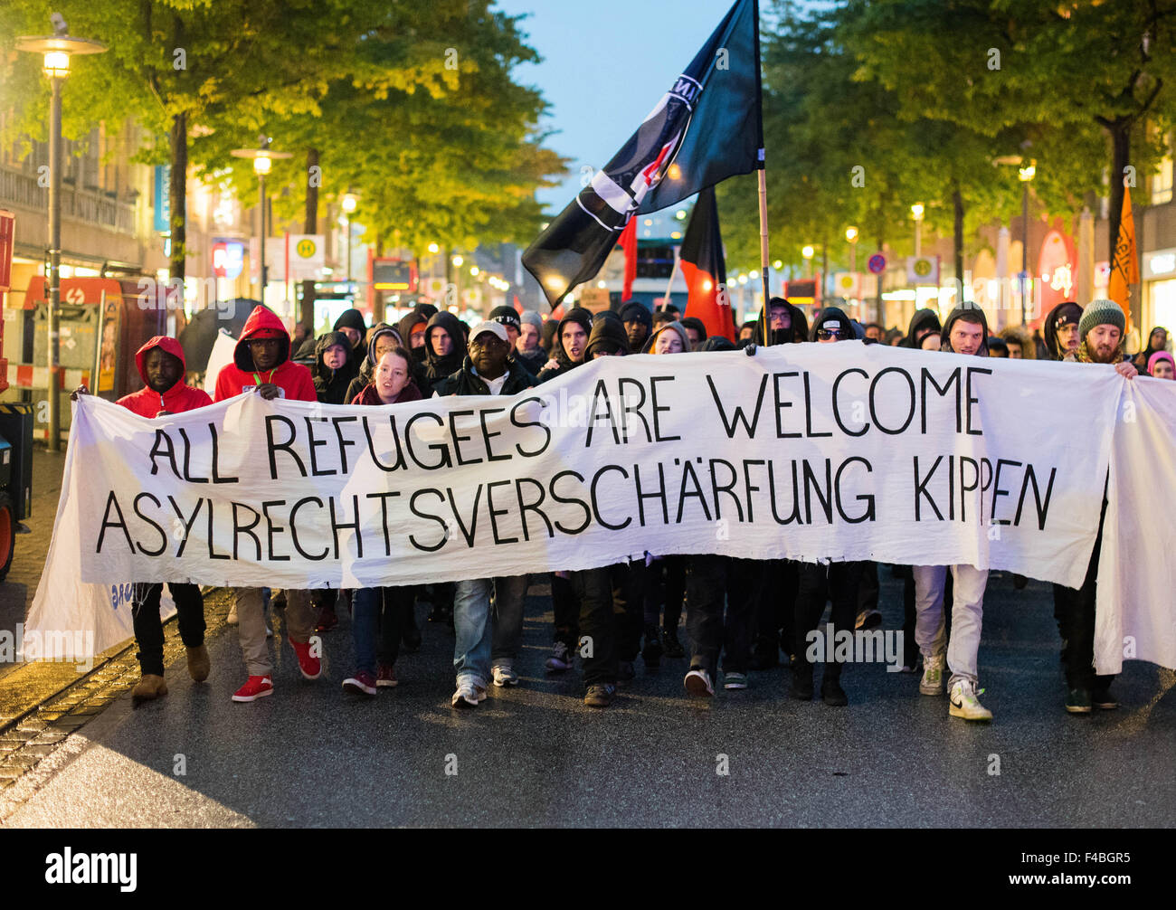 Hamburg, Germany. 15th Oct, 2015. Several hundred people march through the centre of Hamburg to protest the tightening of asylum laws, carrying a banner that reads 'All Refugees are welcome. Asylrechtsverschärfung kippen' (All Refugees are welcome. Overturn the tightening of the asylum laws), in Hamburg, Germany, 15 October 2015. Earlier, the German Bundestag passed a package of controversial changes to asylum law. PHOTO: DANIEL BOCKWOLDT/DPA/Alamy Live News Stock Photo