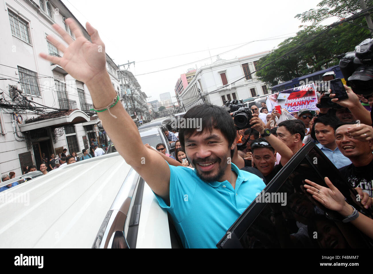 Manila, Philippines. 16th Oct, 2015. Philippine boxer Manny Pacquiao waves to his supporters after filing his certificate of candidacy for senator at the Commission on Elections building in Manila, the Philippines, Oct. 16, 2015. The Philippines' election season kicked off Oct. 12 and Pacquiao is one of the most popular senatorial candidates. Credit:  Rouelle Umali/Xinhua/Alamy Live News Stock Photo