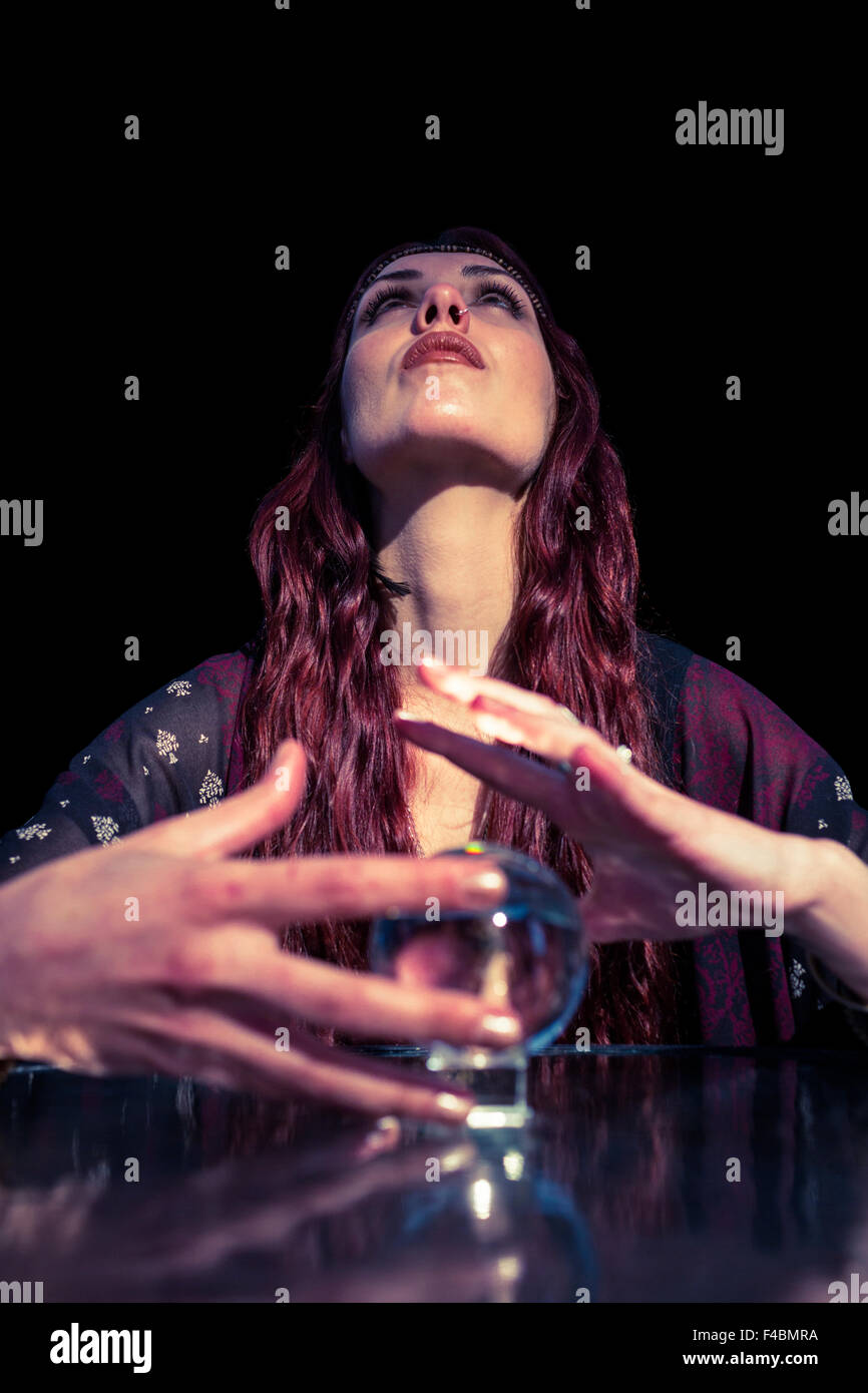 Low angle view of serious fortune teller using crystal ball Stock Photo