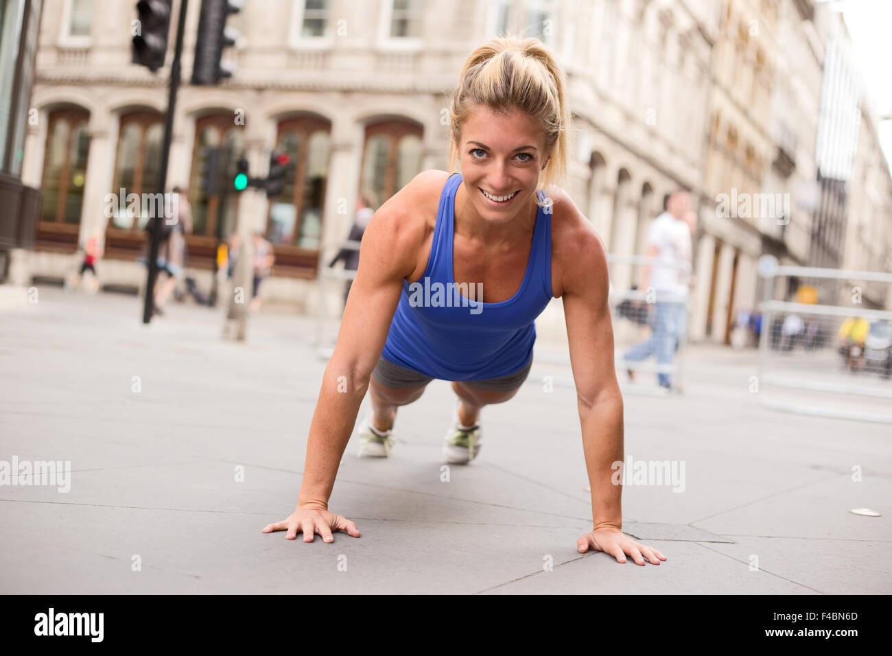 young woman doing push ups Stock Photo