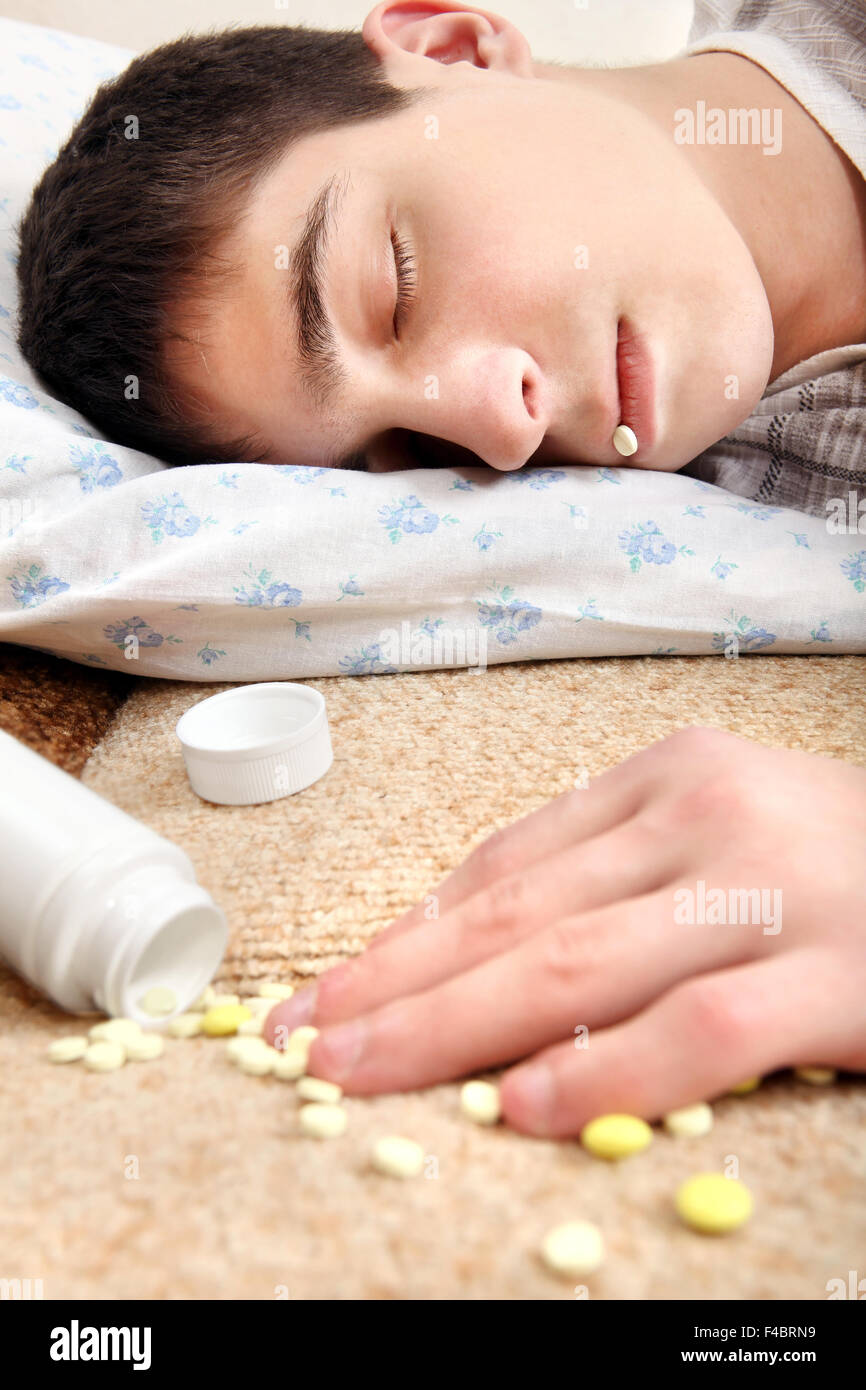 Teenager sleeps near the Pills Stock Photo