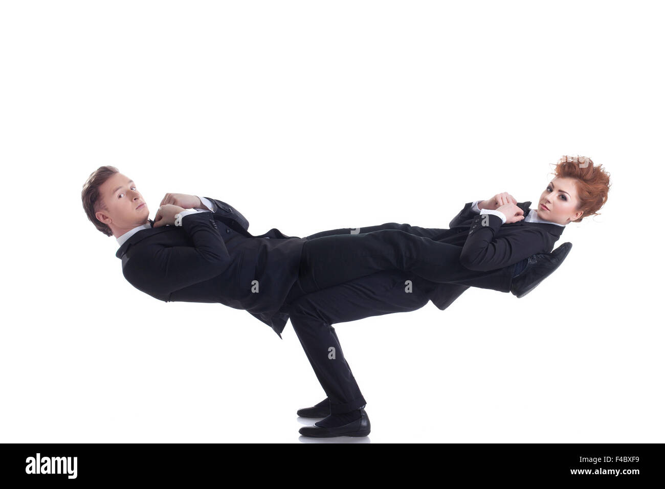 Flexible young people posing as businessmen Stock Photo