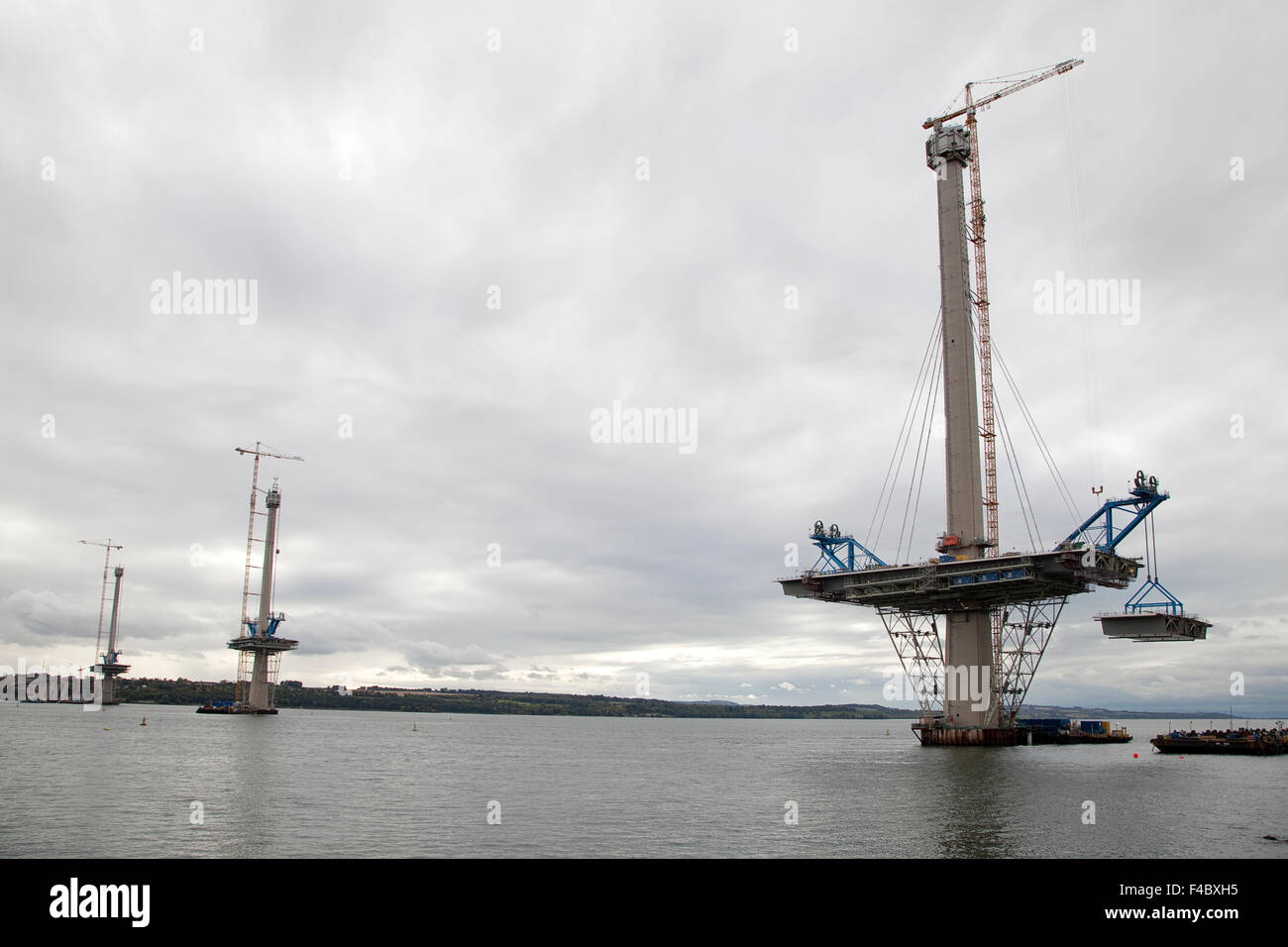 A road section is lifted into place on the northern tower of the Queensferry Bridge across the Firth of Forth near Edinburgh. Stock Photo
