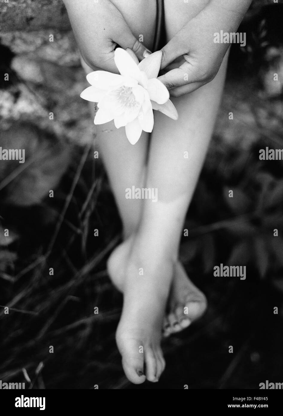 barefoot black and white body part part of children only close to nature conceptual flower human foot human hand leg low Stock Photo