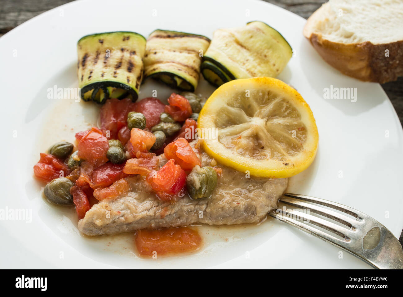 Veal cutlet with tomatoes, capers and lemon sauce Stock Photo Alamy