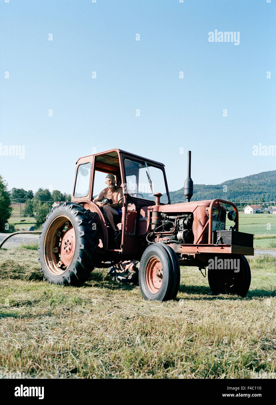 A tractor on a field Stock Photo - Alamy