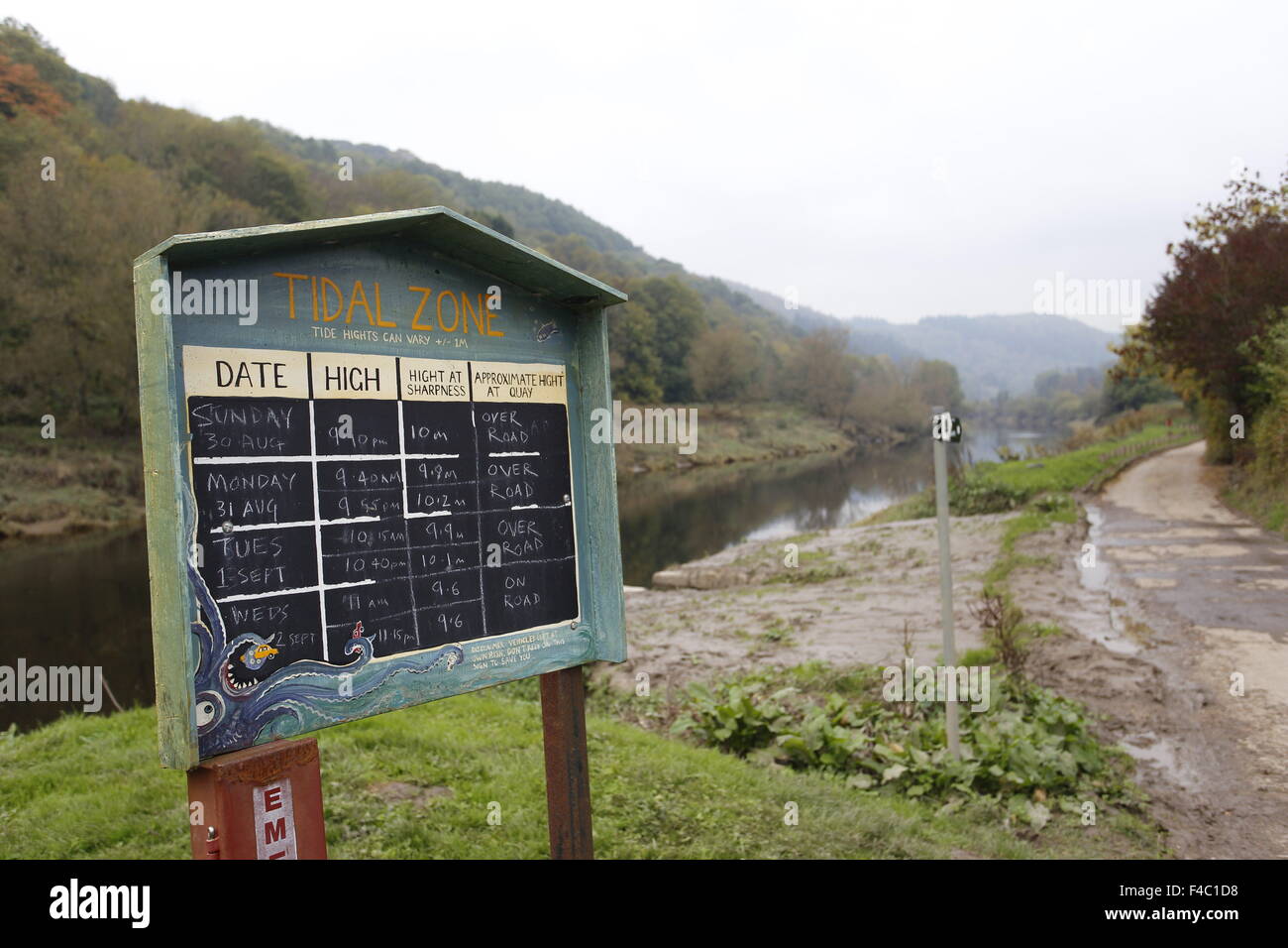 Board with high and low water dates and times at Brockweir Quay on the tidal section of the River Wye Stock Photo