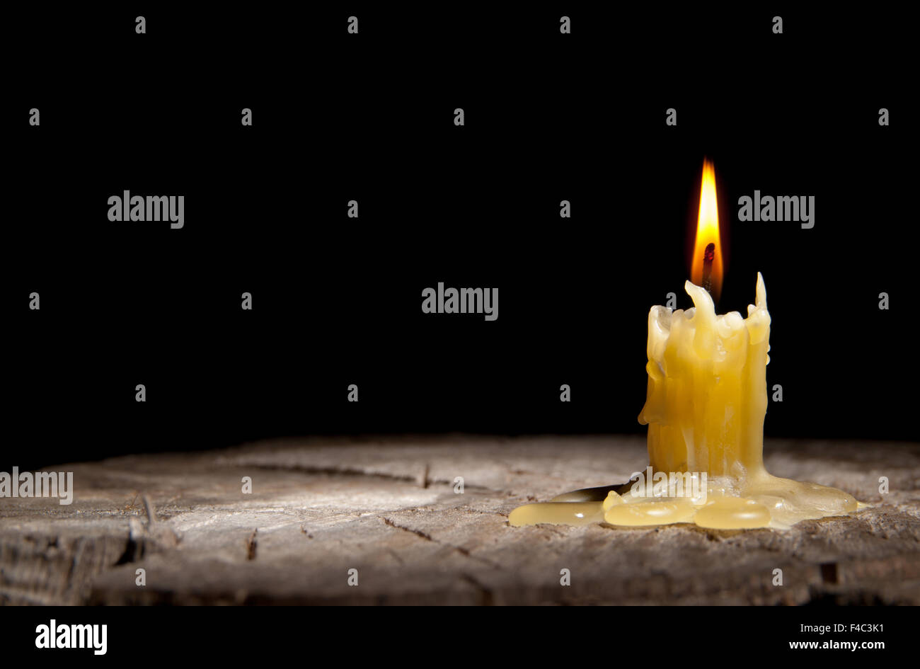 old candle on the black background Stock Photo - Alamy