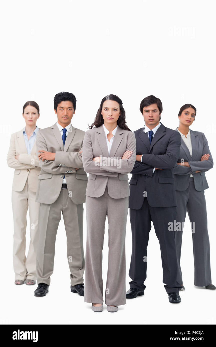 Serious businessteam standing with arms folded Stock Photo - Alamy
