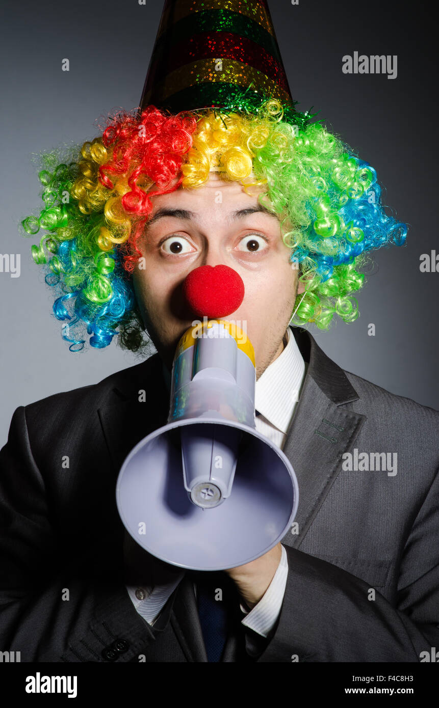 Clown with loudspeaker in funny concept Stock Photo - Alamy