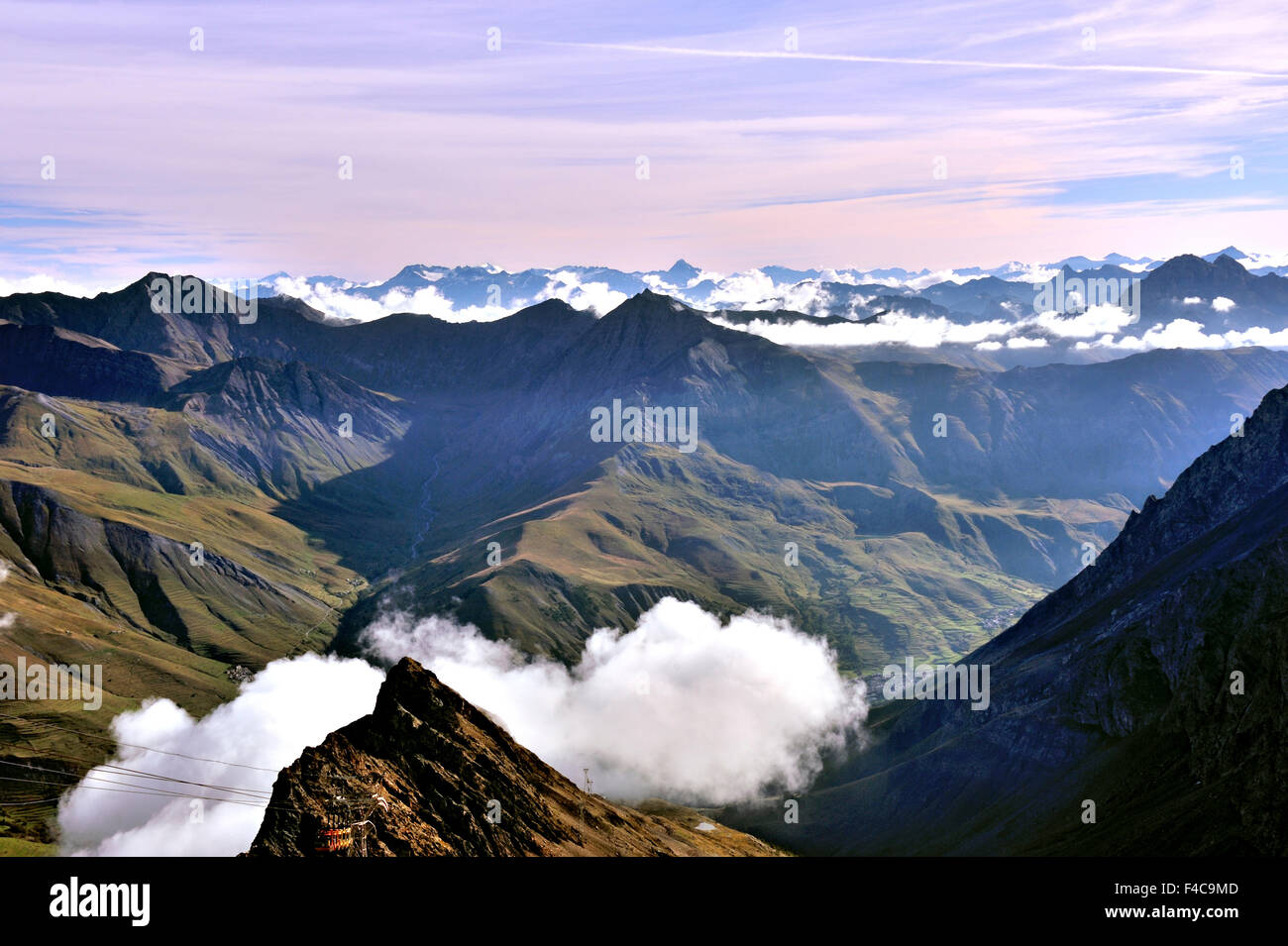 Panorama of the Alps in the early morning, mountain tops over clouds, view from La Meije, region of the Écrins, Alps, France Stock Photo