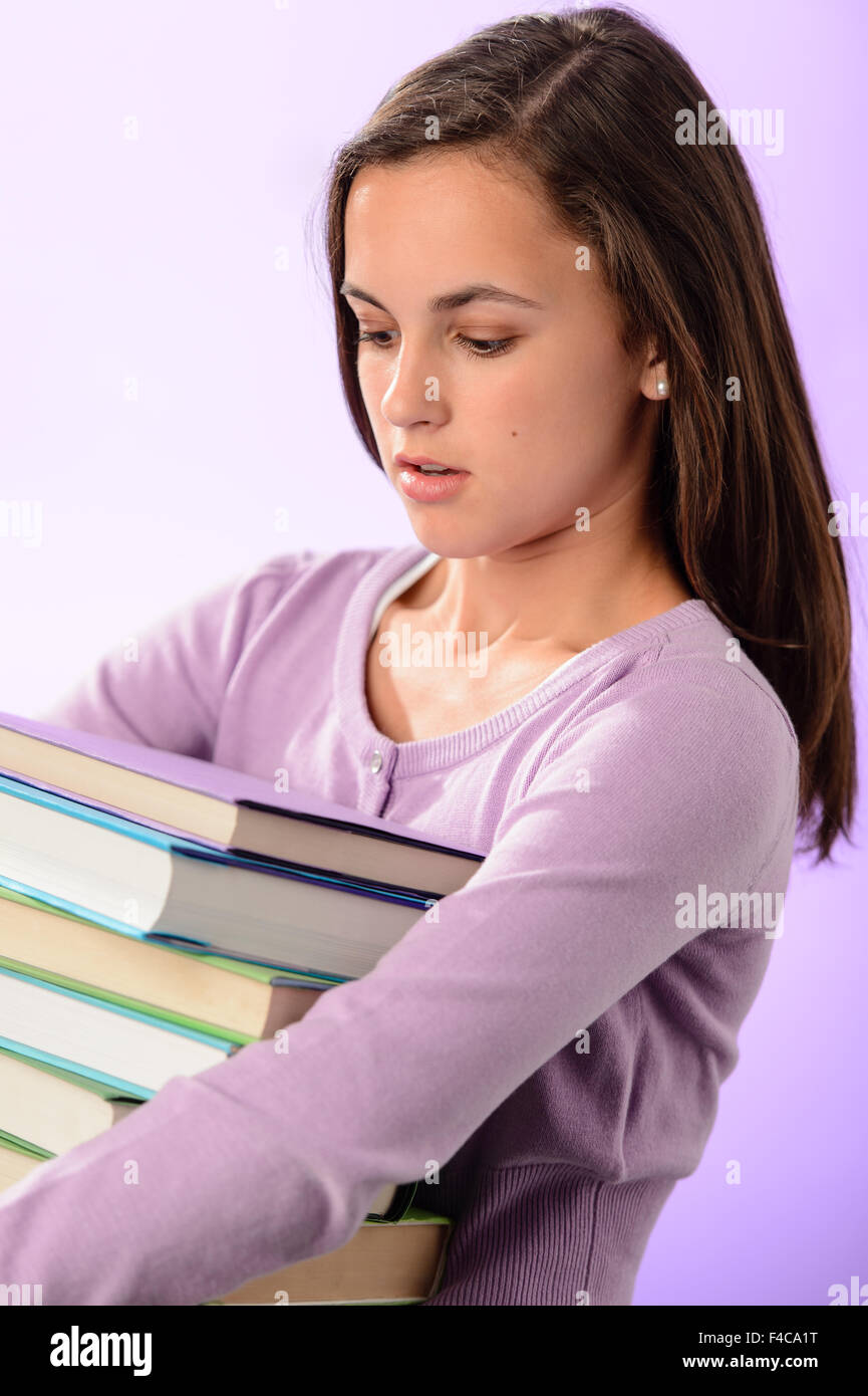 Student girl carry stack of books purple Stock Photo - Alamy
