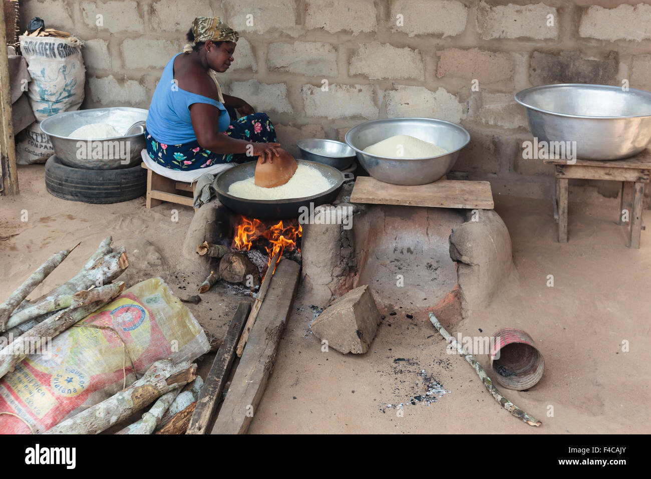 Africa, West Africa, Ghana, Cape Coast, Elmina. Woman cooking in