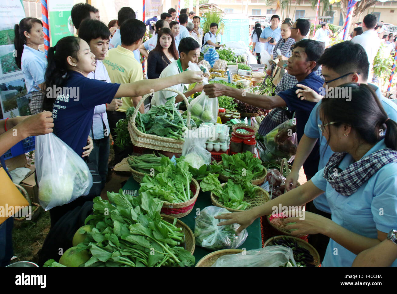 (151016) -- KANDAL (CAMBODIA), Oct. 16, 2015 (Xinhua) -- People buy vegetable at an agriculture fair in Kandal province, Cambodia, Oct. 16, 2015. Cambodia celebrated World Food Day here on Friday, stressing the importance of social protection and agriculture in eradicating hunger and poverty, according to a joint press statement by the Cambodian Ministry of Agriculture, the Food and Agriculture Organization of the United Nations (FAO) and the United Nations World Food Programme (WFP). (Xinhua/Sovannara) Stock Photo