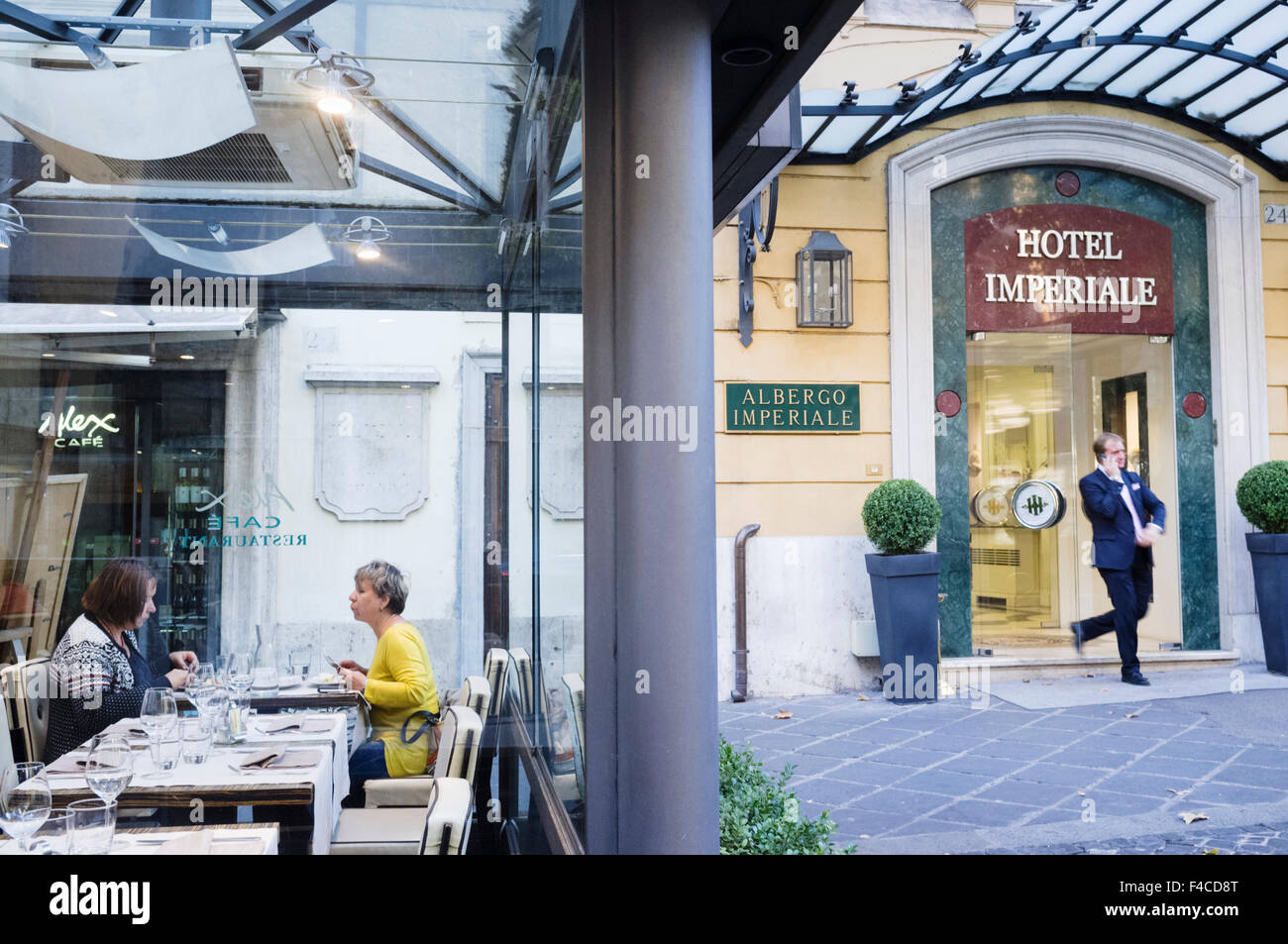 People at elegant outdoor restaurant next to the Hotel Imperiale in Via Veneto, Rome, Italy Stock Photo