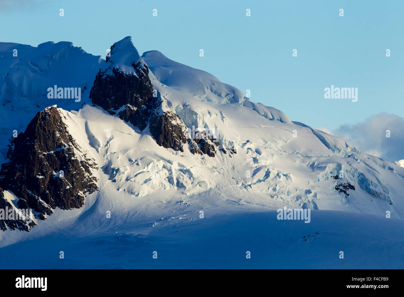 Antarctica, Setting sun lights mountain peaks on Antarctic Peninsula