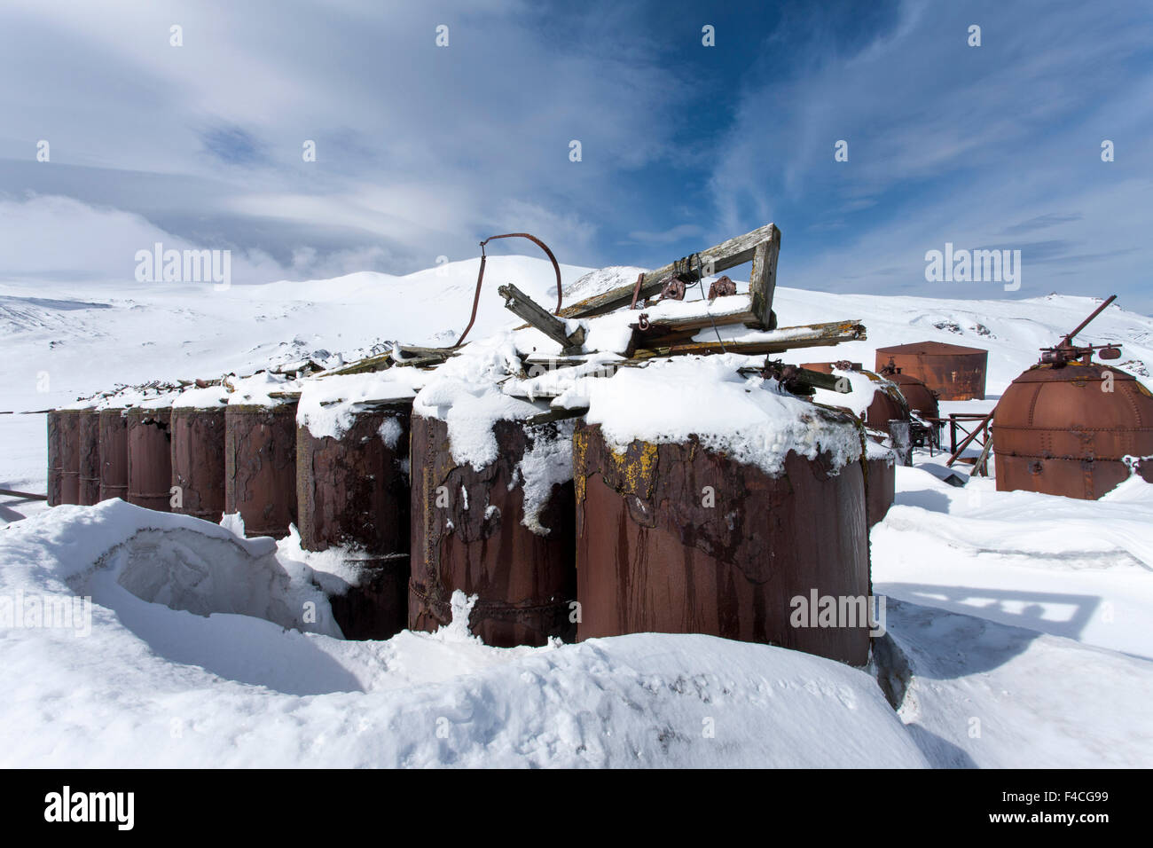 Antarctica, South Shetland Islands, Rusted boilers in late winter snow at abandoned whaling station at Whalers Cove on Deception Island. Stock Photo