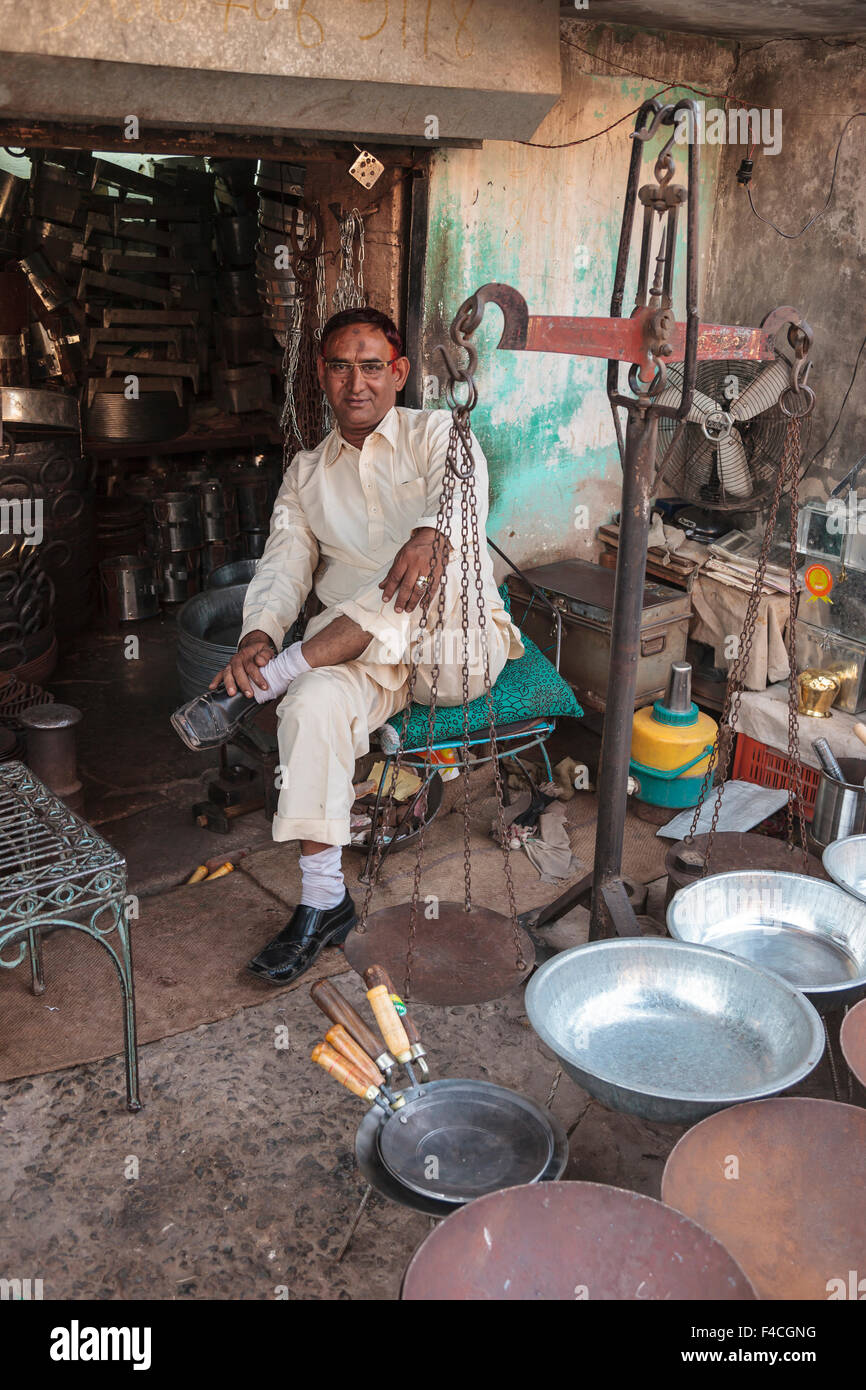 India, Rajasthan, Jodhpur. Man selling cookware in market Stock Photo