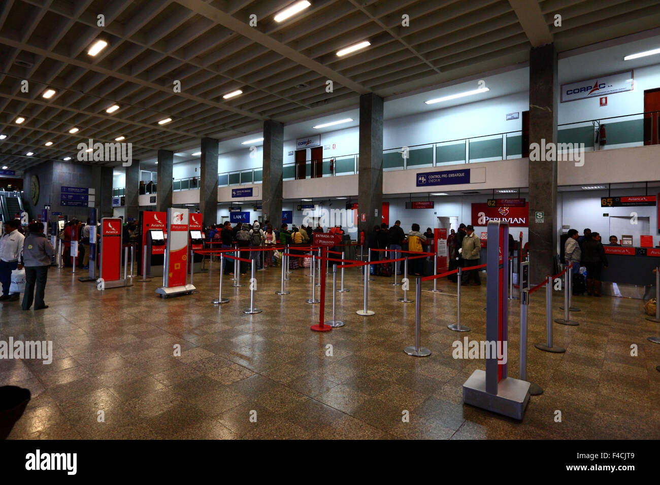 Passengers queuing at check in desks inside Alejandro Velasco Astete International Airport CUZ terminal building, Cusco Peru Stock Photo