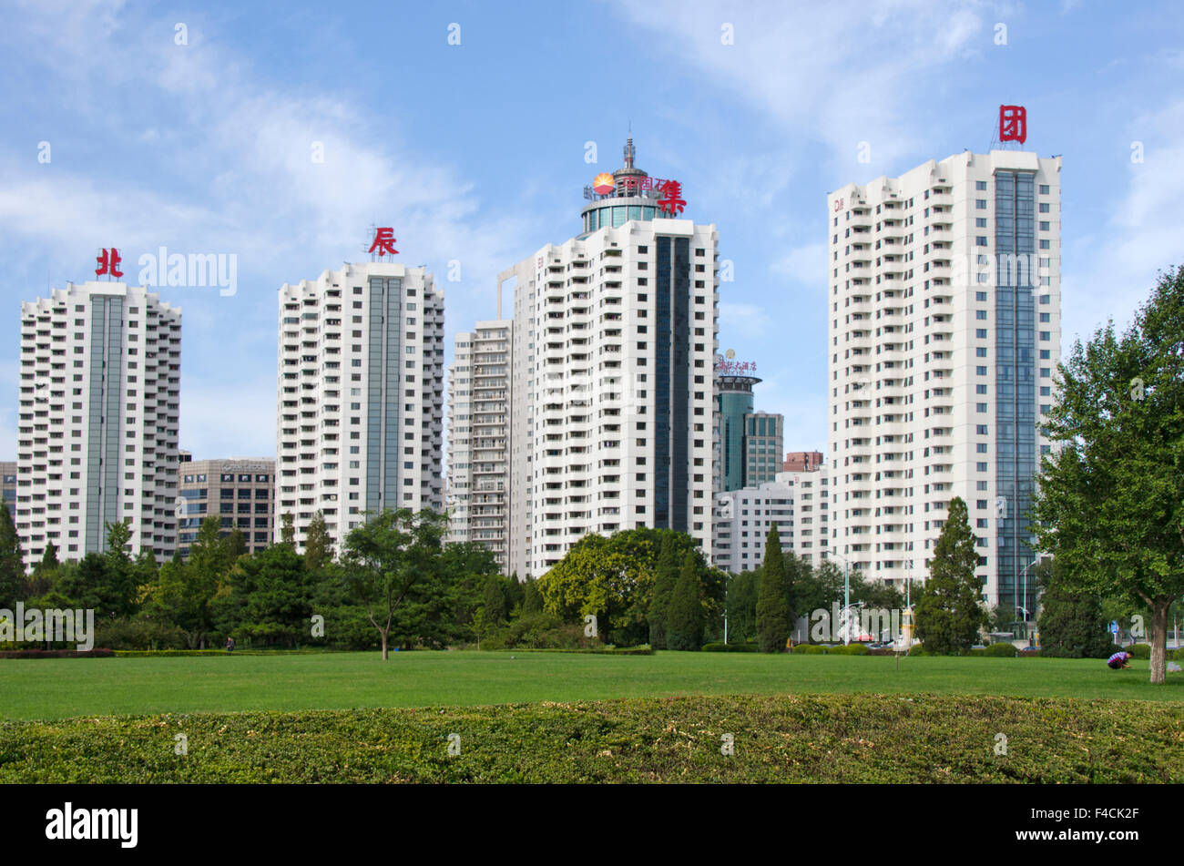 View of China, Beijing. A group of new apartment buildings stand in a park-like ...