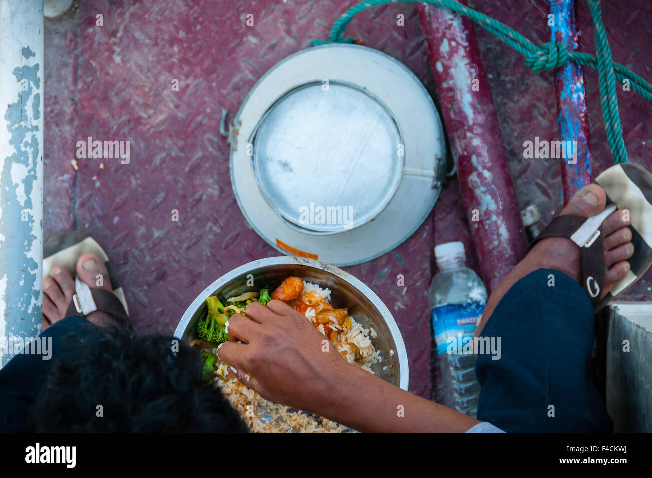 Asian man eating food from above Stock Photo