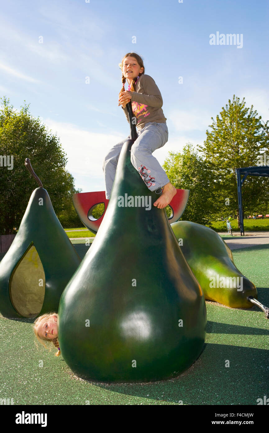 Two girls playing in a playground Stock Photo - Alamy