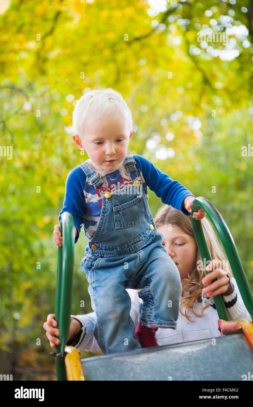 Two girls on a slide Stock Photo - Alamy