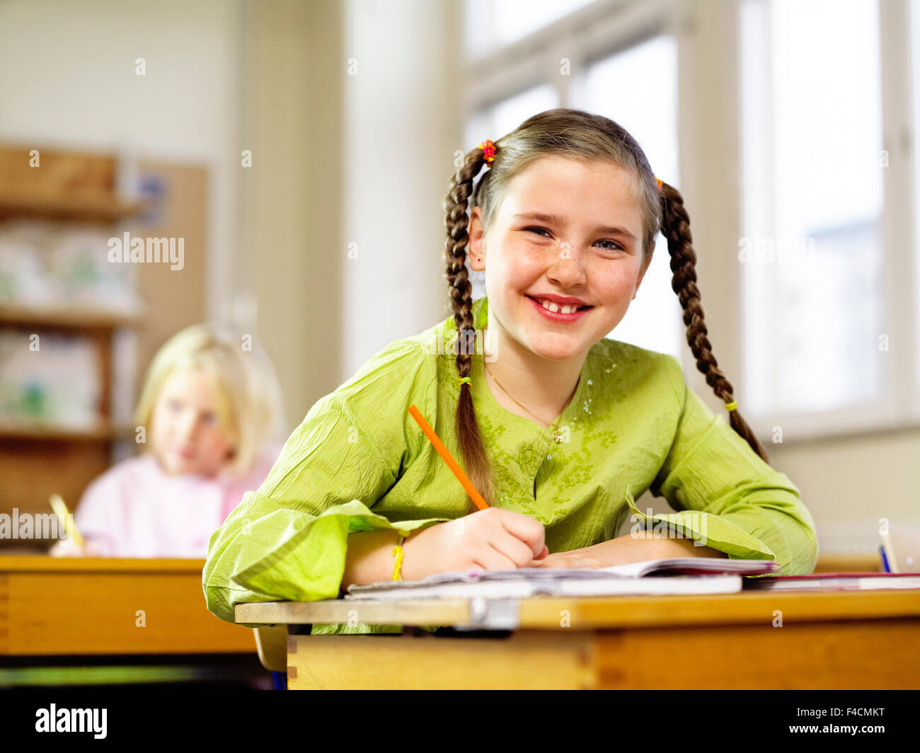 Girl sitting in her school bench Stock Photo Alamy