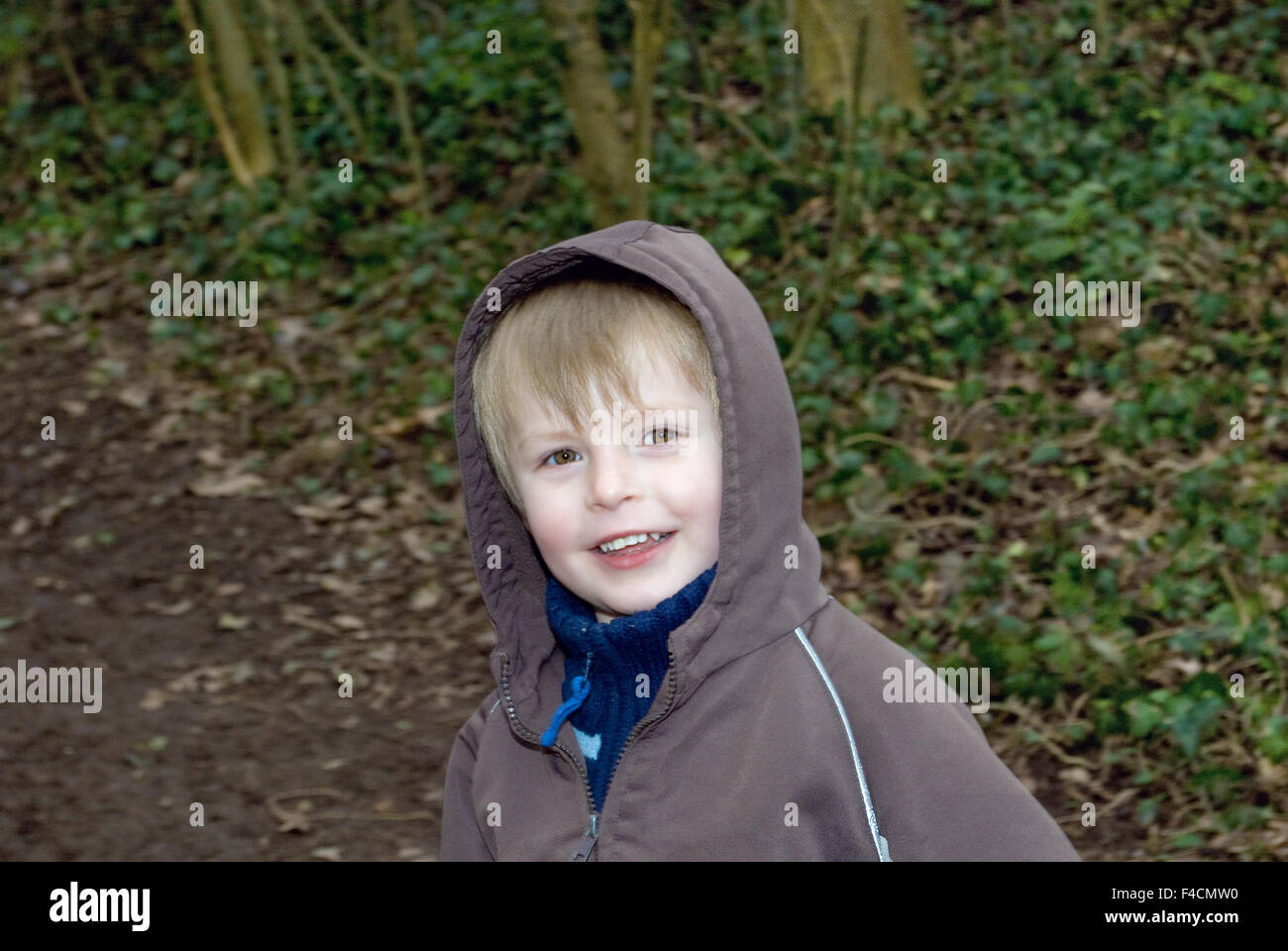 Happy four year old boy out in the woods. Stock Photo
