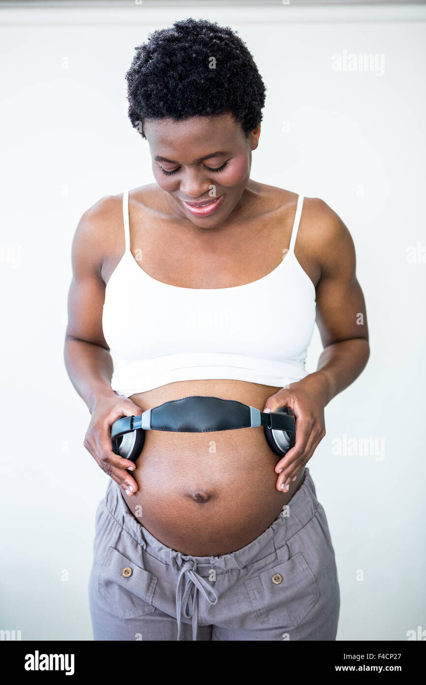 Close up of pregnant woman using headphones on her belly Stock Photo by  ©Dmyrto_Z 136380656