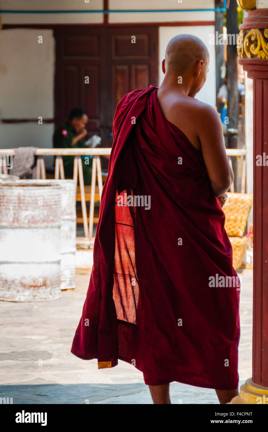 Standing Red Monk from behind in Burma Myanmar Stock Photo