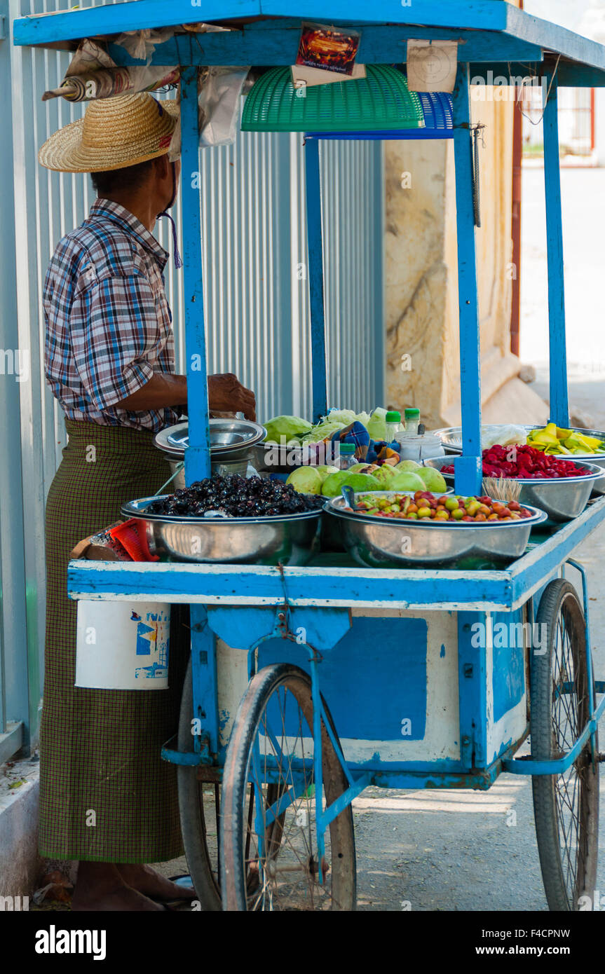 Asian man selling fruits and vegetables Stock Photo