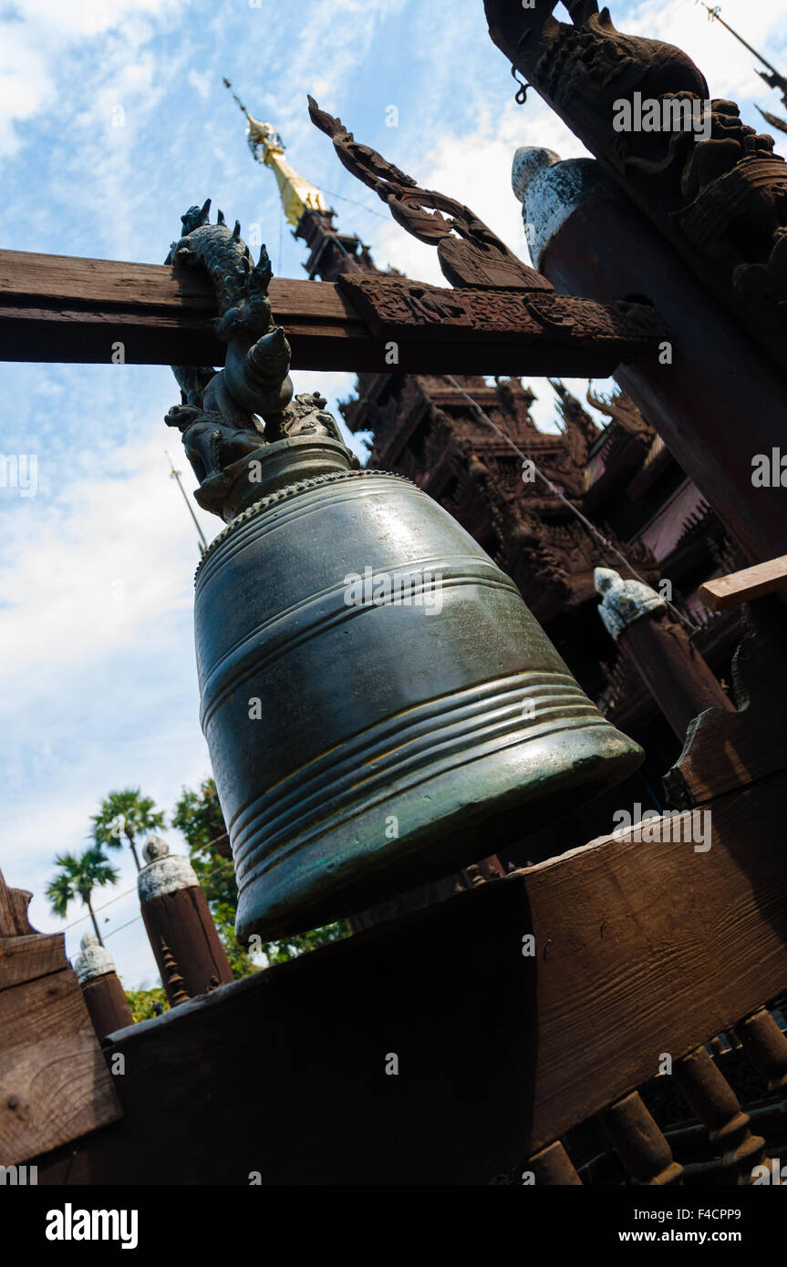 Big bell at wooden temple in Mandalay Stock Photo