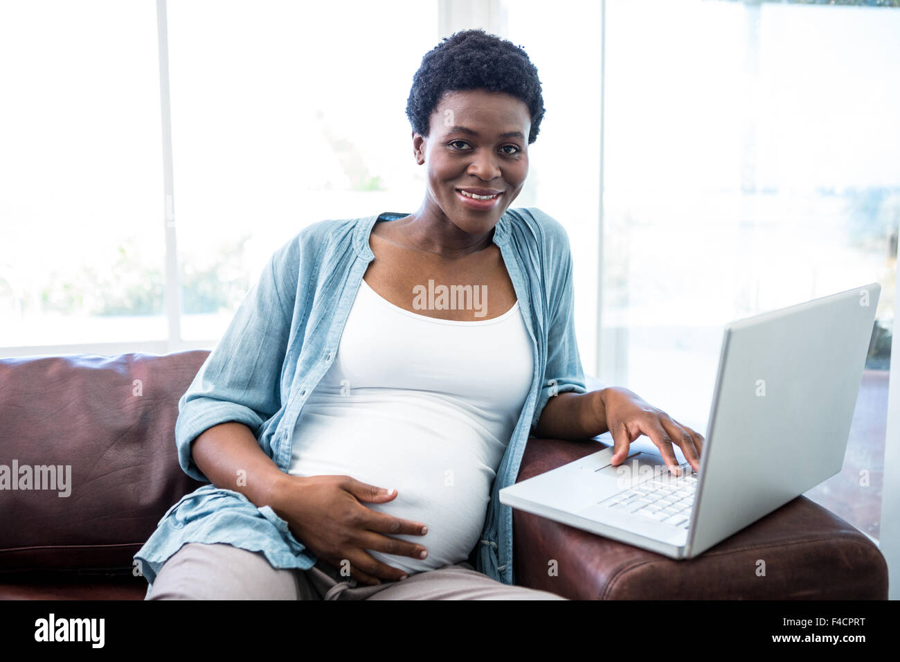 Smiling woman using her laptop Stock Photo - Alamy