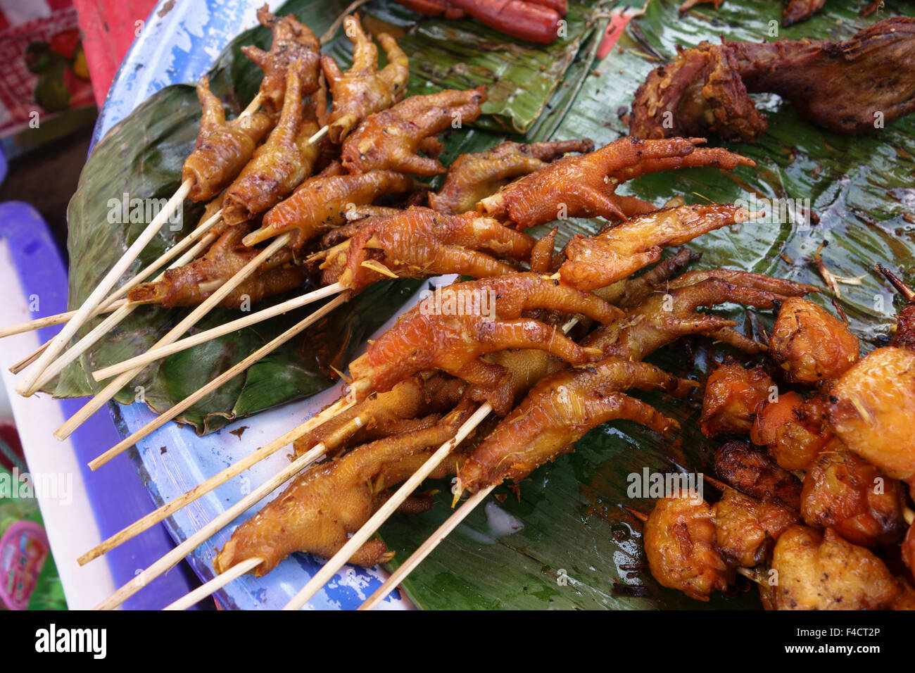 Laos, Luang Prabang. Grilled chicken feet at Hmong New Year's