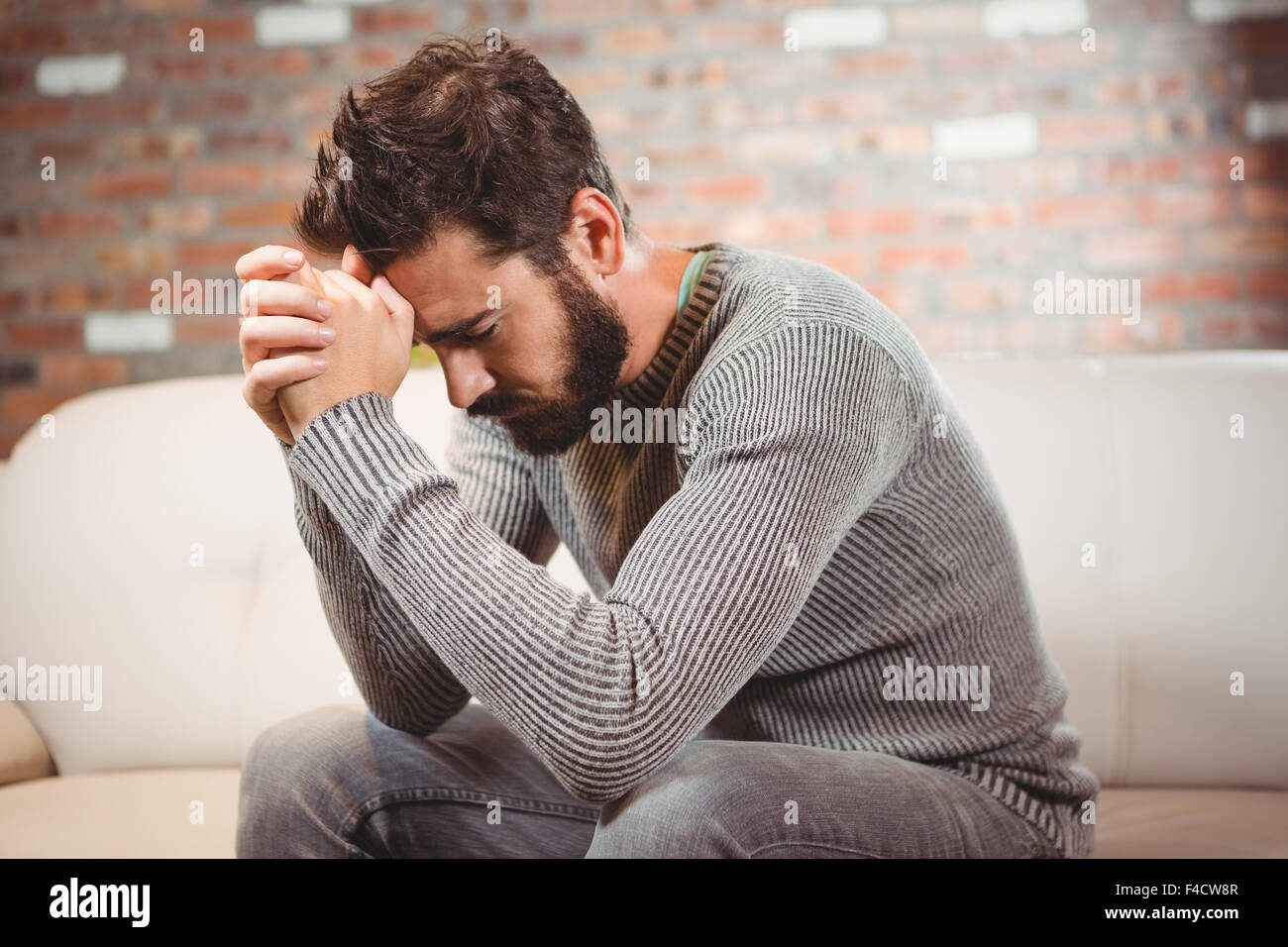 Man with hands clasped Stock Photo
