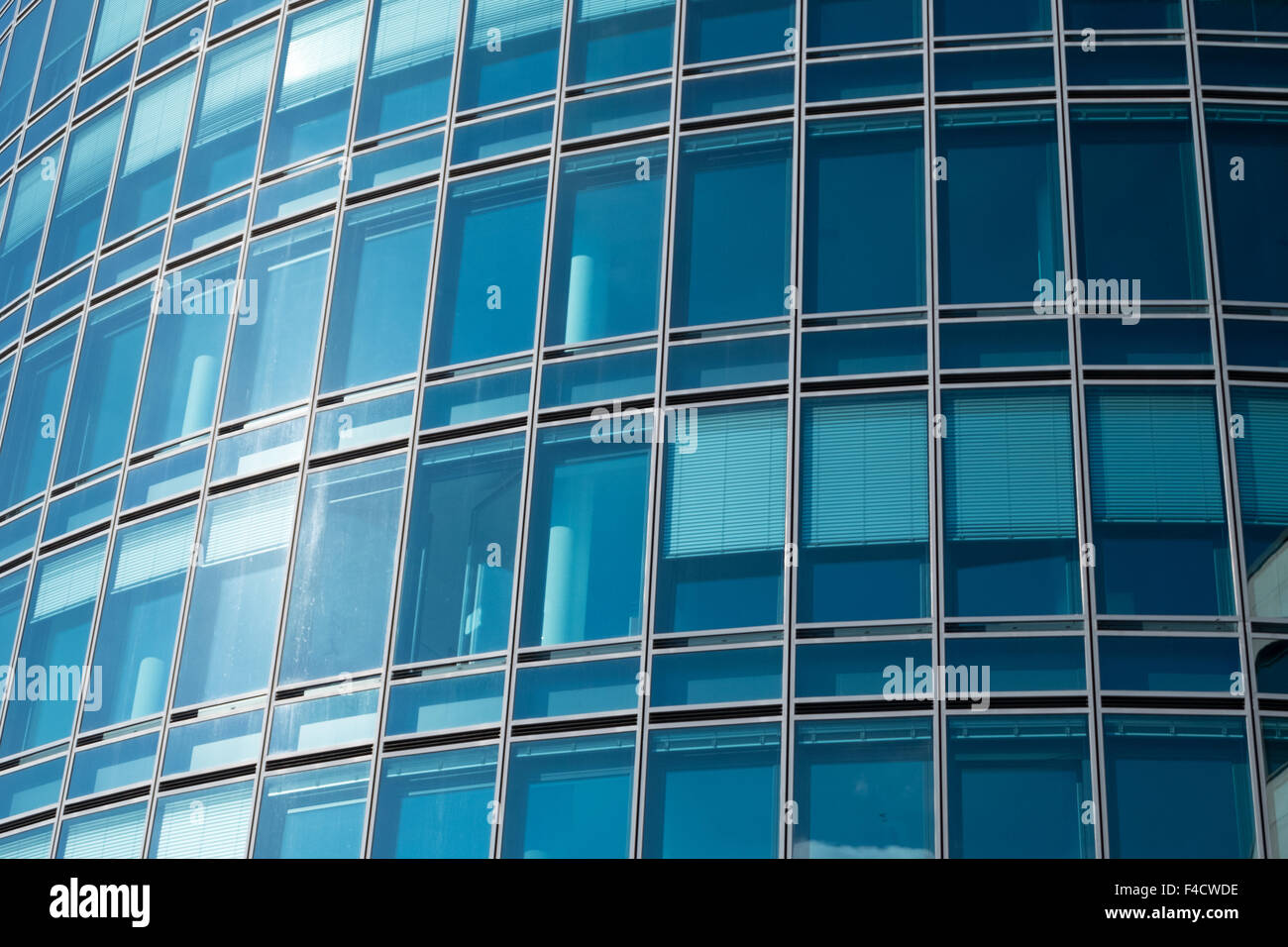 Office building with blue windows and shutters Stock Photo - Alamy