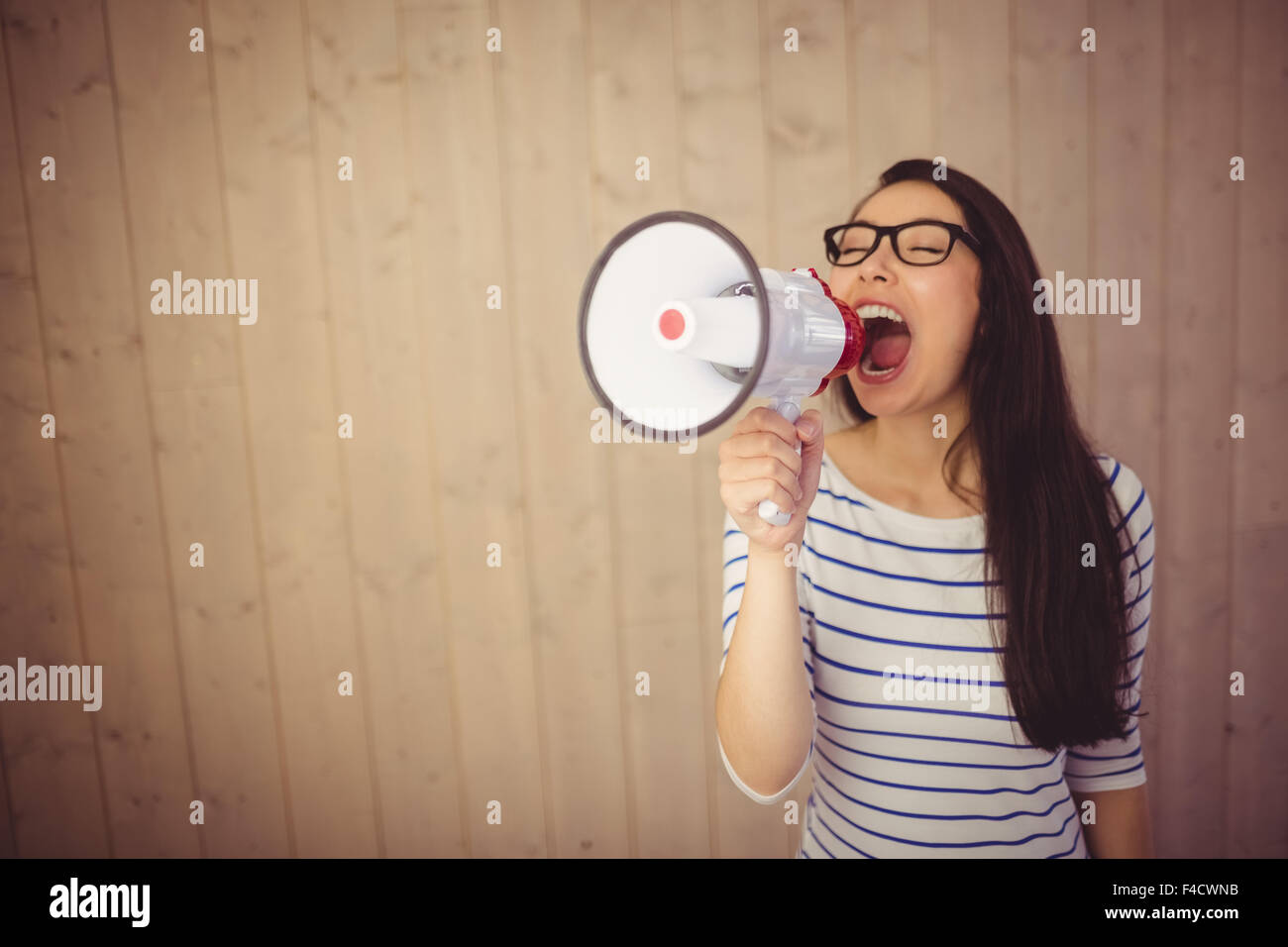 Beautiful woman shouting with megaphone Stock Photo