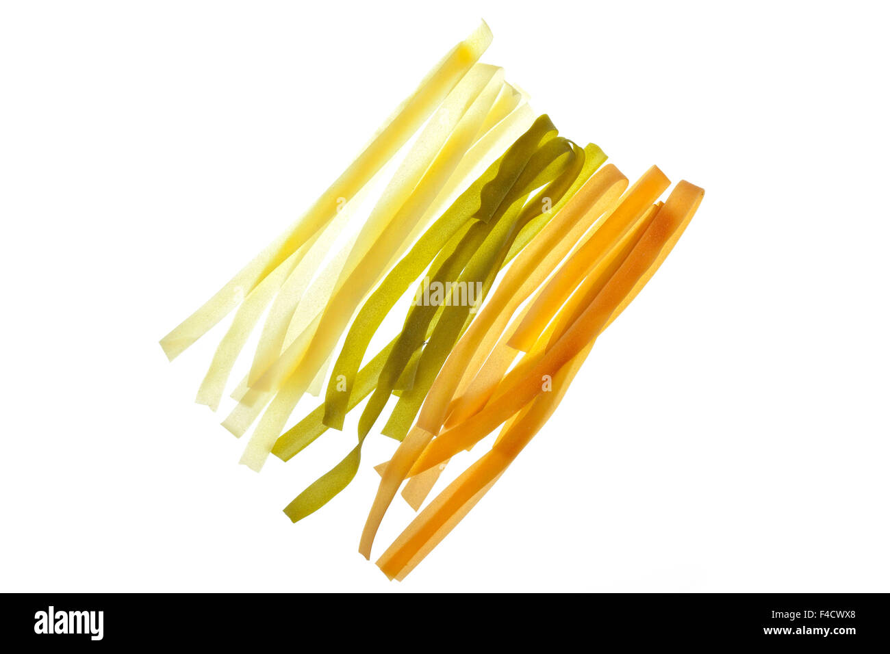 Uncooked colourful Pappardelle Tricolori Pasta, white background. Stock Photo