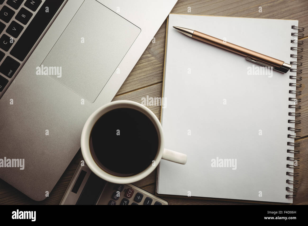 Overhead of notepad with coffee and calculator Stock Photo