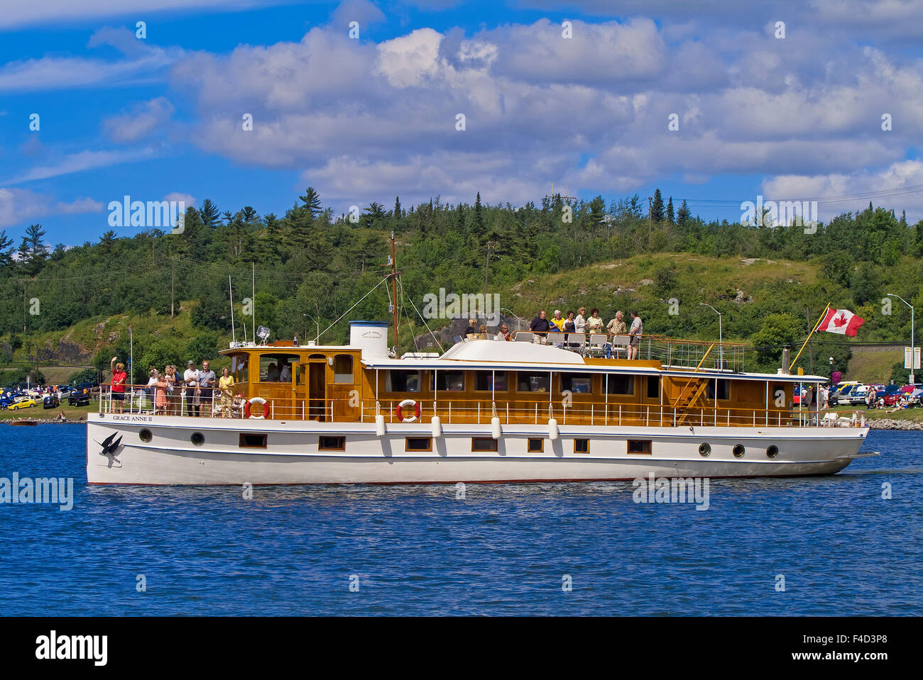 Canada, Ontario, Kenora. People on vintage wooden boat. Credit as Mike