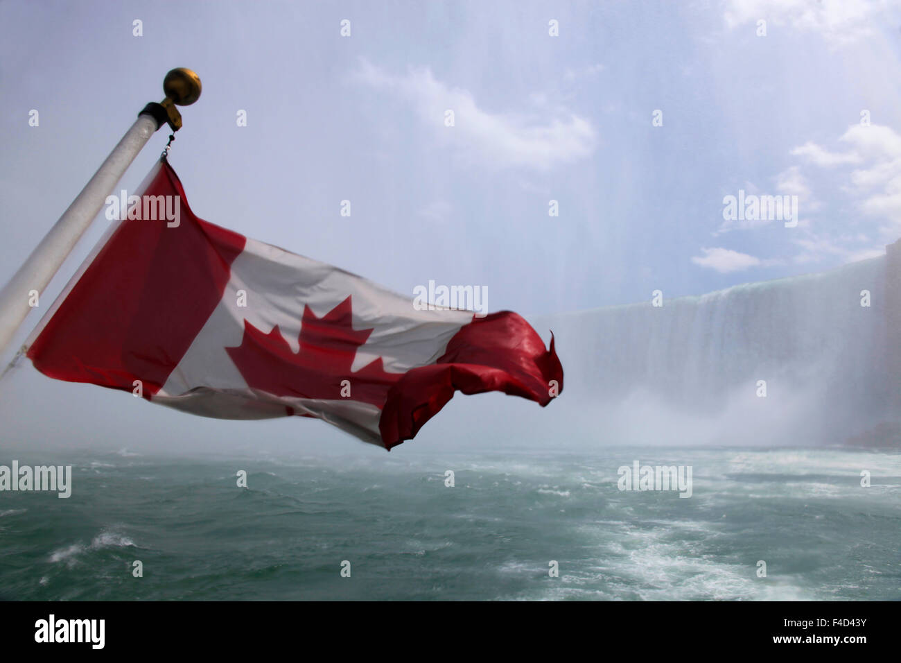 Canadian flag at windy Niagara Falls, Ontario, Canada. Stock Photo