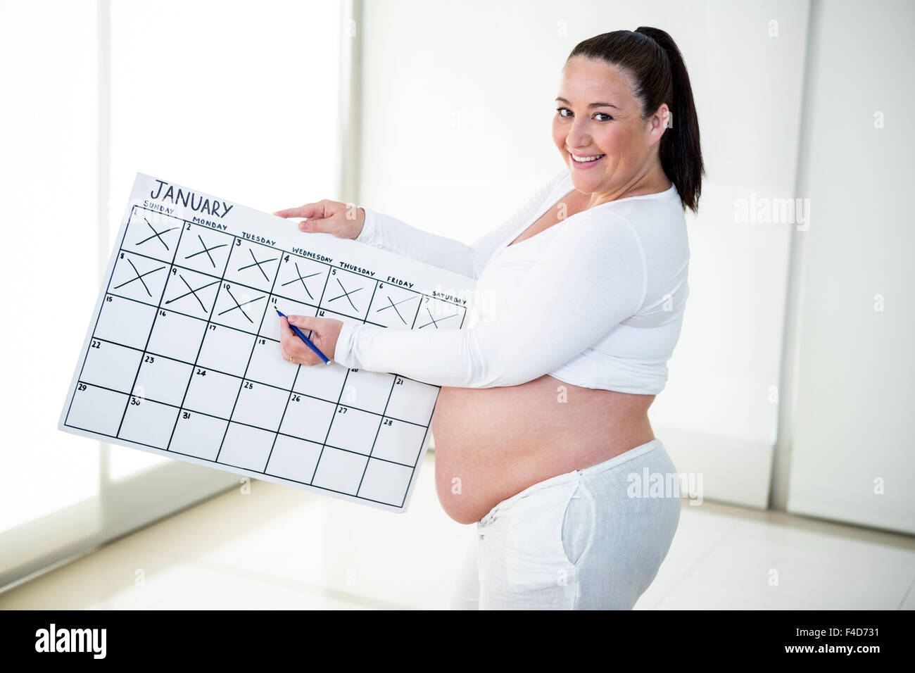 Pregnant woman marking off a calendar Stock Photo Alamy